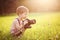 Smiling kid holding a DSLR camera in park