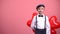 Smiling kid in vintage clothes hiding heart-shaped balloons, Valentines day