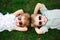 Smiling kids at the garden in sunglasses