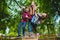 Smiling kids having fun at playground. Children playing outdoors in summer. Teenagers riding on a swing outside