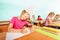 Smiling kids writing in classroom during lesson