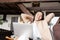 Smiling korean woman resting with hands behind her head, using laptop and relaxing at home