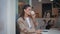 Smiling lady drinking espresso in small restaurant alone close up. Happy woman