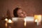 Smiling lady enjoy relaxed spa bath with candle