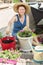 Smiling lady gardener potting up spring flowers