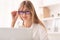 Smiling Lady Looking Through Eyeglasses At Laptop Working In Office