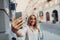 Smiling lady with shopping bags making selfie on the street