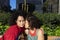 Smiling lesbian couple embracing and relaxing on a park bench