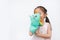Smiling little Asian child girl hand wear and playing Rhinoceros puppets on white background. Educations concept