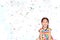 Smiling little Asian kid girl with many falling colorful tiny confetti pieces on white background. Happy New Year or