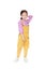 Smiling little Asian kid girl in pink-yellow dungarees poses touched hair keep back isolated on white background. Full length of