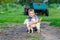 Smiling little boy affectionately embraces a red cat. outdoor