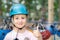 Smiling little cute blond caucasian girl in helmet showing thumbs up. Safety accessories of extreme entertainment on background. A