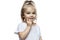 Smiling little girl 2 years old in a white T-shirt. The blond baby put her hands to her face. Astonishment and joy. Isolated on