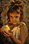 smiling little girl in an antique tunic with candles in her hands