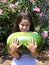 Smiling little girl with an enormous WATERMELON