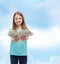 Smiling little girl giving dollar cash money