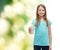 Smiling little girl giving glass of milk