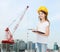 Smiling little girl in hardhat with clipboard