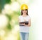 Smiling little girl in hardhat with clipboard