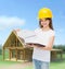 Smiling little girl in hardhat with clipboard