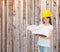 Smiling little girl in hardhat with clipboard