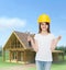 Smiling little girl in hardhat with hammer