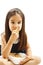 Smiling little girl holding a bowl with cookie or biscuit