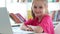 Smiling little girl with laptop at school