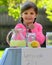 Smiling little girl at lemonade stand in summer