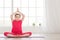 Smiling little girl in lotus position