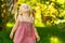 Smiling little girl in a meadow in the park.