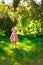 Smiling little girl in a meadow in the park.