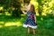 Smiling little girl in a meadow in the park.