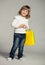 Smiling little girl with multicolored shopping bags