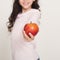 Smiling little girl offering red apple
