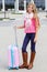 Smiling little girl with pink travel suitcase