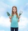 Smiling little girl with rake and scoop