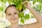 Smiling little girl with tree branch in one hand portrait. Beauty, green, love nature