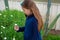 Smiling little latina girl in garden picking flowers