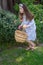 Smiling little latina girl in garden in Spring dress with Basket