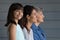 Smiling little Latino girl pose with mother and grandmother