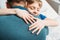 Smiling little son hugging father in hospital chamber