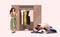 Smiling long-haired girl standing in front of opened closet with apparel hanging inside and pile of clothes on floor