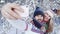 Smiling lovely couple taking selfie in snowbound wood