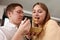 Smiling loving husband feeding wife, young couple enjoying tender moment, romantic date, having fun, eating japanese