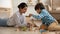 Smiling loving Indian mother and little son playing with toys