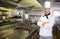 Smiling male cook with arms crossed in the kitchen