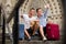 Smiling male couple with luggage doing selfie and sitting