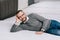 smiling male customer in eyeglasses lying on mattress